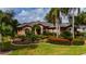 Single-story home with landscaped yard and palm trees at 2005 Tocobaga Ln, Nokomis, FL 34275