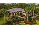 Single-story home with tile roof, landscaping, and palm trees at 2005 Tocobaga Ln, Nokomis, FL 34275