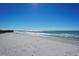 Expansive beach view with white sand and blue ocean at 2045 Gulf Of Mexico Dr # M1-303, Longboat Key, FL 34228