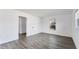 Well-lit bedroom with wood-look floors and access to a hallway at 2420 Sunnyside St, Sarasota, FL 34239