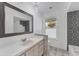 Updated bathroom with a large vanity and patterned tile shower surround at 2420 Sunnyside St, Sarasota, FL 34239