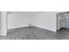 Open concept living room with wood-look floors and access to pool at 2420 Sunnyside St, Sarasota, FL 34239
