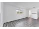Spacious bedroom with wood-look floors and ensuite bathroom access at 2420 Sunnyside St, Sarasota, FL 34239