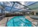 Inviting kidney-shaped pool with screened enclosure at 2420 Sunnyside St, Sarasota, FL 34239