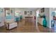 Bright dining room with wood floors and view into living room at 2609 Riverbluff Pkwy # 146, Sarasota, FL 34231