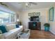 Relaxing living room with sofa, wood floors and TV stand at 2609 Riverbluff Pkwy # 146, Sarasota, FL 34231