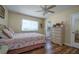 Cozy bedroom with wood flooring and a ceiling fan at 2609 Riverbluff Pkwy # 146, Sarasota, FL 34231
