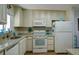 Kitchen with granite countertops and white cabinets at 2609 Riverbluff Pkwy # 146, Sarasota, FL 34231