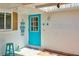 Inviting entryway with teal front door and small stool at 2609 Riverbluff Pkwy # 146, Sarasota, FL 34231