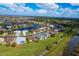 Community overview featuring lake, houses, and landscaping at 2760 Suncoast Lakes Blvd, Punta Gorda, FL 33980