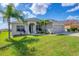 Single-story house with a large front yard and palm trees at 2760 Suncoast Lakes Blvd, Punta Gorda, FL 33980