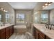 Bathroom featuring a tub, walk-in shower, and double sinks at 409 147Th Ne Ct, Bradenton, FL 34212
