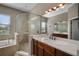 Bathroom with a walk-in shower, soaking tub, and dual sinks at 409 147Th Ne Ct, Bradenton, FL 34212