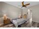 Bedroom with wood-look flooring, neutral tones, lamps, and windows at 409 147Th Ne Ct, Bradenton, FL 34212