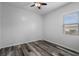Bedroom with ceiling fan, window, and wood flooring at 409 147Th Ne Ct, Bradenton, FL 34212