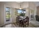 Dining area with a patio door, a window view, and a modern pendant light at 409 147Th Ne Ct, Bradenton, FL 34212