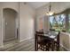 Cozy dining area with wood floors, a modern pendant light, and a window view at 409 147Th Ne Ct, Bradenton, FL 34212