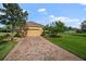 Attached two-car garage with brick-paved driveway and well-maintained landscaping; attractive curb appeal at 409 147Th Ne Ct, Bradenton, FL 34212