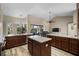 Modern kitchen with marble countertops, wood cabinets, an island, and stainless steel appliances at 409 147Th Ne Ct, Bradenton, FL 34212