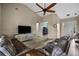 Spacious living room featuring vaulted ceilings, ceiling fan, and comfortable leather sofas at 409 147Th Ne Ct, Bradenton, FL 34212