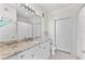 Bathroom with granite countertop, large mirror, and shower at 4221 W Spruce St # 1326, Tampa, FL 33607