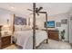 Well-lit main bedroom featuring a four-poster bed, neutral decor, and a ceiling fan at 4589 Trails Dr, Sarasota, FL 34232