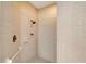 The renovated shower has a rainfall shower head and white tiled walls at 4589 Trails Dr, Sarasota, FL 34232