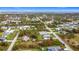 Aerial view of a residential area near the waterfront, showing houses and open areas at 5339 Gulfport Ter, Port Charlotte, FL 33981