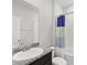 Bathroom featuring granite countertop, ample mirror, and tub with shower and blue striped curtain at 5719 Woodland Sage Dr, Sarasota, FL 34238