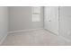 Bedroom features neutral carpet, light gray walls, double door closet, and a window at 5719 Woodland Sage Dr, Sarasota, FL 34238