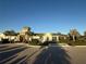 Exterior view of the community clubhouse with lush landscaping and ample parking at 5719 Woodland Sage Dr, Sarasota, FL 34238