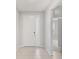 Bright entryway featuring tile flooring, white walls, and a view into the carpeted living space at 5719 Woodland Sage Dr, Sarasota, FL 34238
