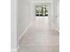 Light and airy hallway with tile floors and access to other rooms at 5719 Woodland Sage Dr, Sarasota, FL 34238