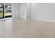 Open living room showcases tile flooring, light walls and sliding glass doors to the exterior at 5719 Woodland Sage Dr, Sarasota, FL 34238