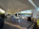 Outdoor patio with tables, chairs and view of the community pool and tropical landscaping at 5719 Woodland Sage Dr, Sarasota, FL 34238