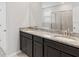 Double vanity bathroom with granite countertop and dark brown cabinets at 5719 Woodland Sage Dr, Sarasota, FL 34238