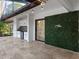 Outdoor kitchen with white cabinets and green wall at 6817 Riverview Blvd, Bradenton, FL 34209