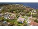 Aerial view of a house with a pool in a residential area near the water at 6817 Riverview Blvd, Bradenton, FL 34209