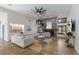 Spacious living room featuring a large sectional sofa, stone fireplace and a beautiful rug at 6817 Riverview Blvd, Bradenton, FL 34209