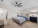 Main bedroom with king bed and ceiling fan at 6817 Riverview Blvd, Bradenton, FL 34209