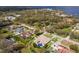 Aerial view of a house with a pool in a residential area near the water at 6817 Riverview Blvd, Bradenton, FL 34209