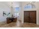 Round dining table with four brown leather chairs at 6817 Riverview Blvd, Bradenton, FL 34209