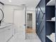 Modern bathroom with white cabinets and walk-in closet at 6817 Riverview Blvd, Bradenton, FL 34209