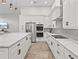 Spacious kitchen with white cabinets, quartz countertops, and stainless steel appliances at 6817 Riverview Blvd, Bradenton, FL 34209