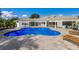 Inviting kidney-shaped pool with a large patio and lounge chairs at 6817 Riverview Blvd, Bradenton, FL 34209