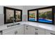 Kitchen features white cabinets, quartz countertops, and a view of the pool at 6817 Riverview Blvd, Bradenton, FL 34209