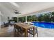 Outdoor patio with pool, dining table, and seating area at 6817 Riverview Blvd, Bradenton, FL 34209