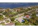 Aerial view showcasing a house with a pool in a quiet neighborhood near the water at 6817 Riverview Blvd, Bradenton, FL 34209