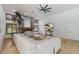 Living room with sectional sofa, stone fireplace, and large TV at 6817 Riverview Blvd, Bradenton, FL 34209