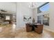 Round dining table with four brown leather chairs, view of living room at 6817 Riverview Blvd, Bradenton, FL 34209